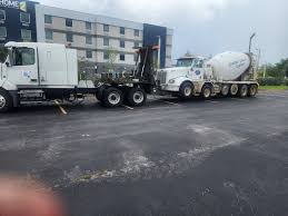 Truck towing mixer vehicle